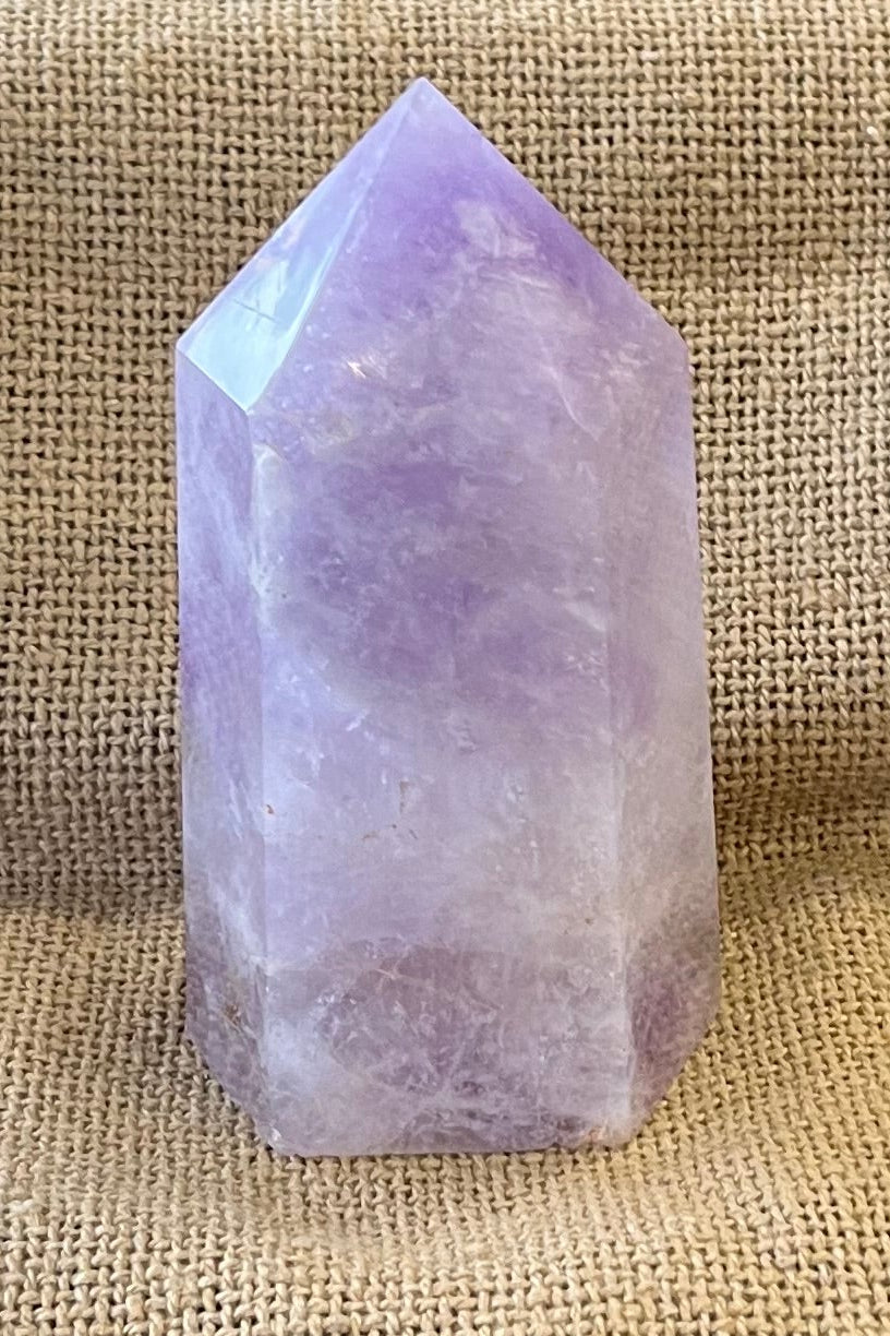 Amethyst crystal on a woven mat