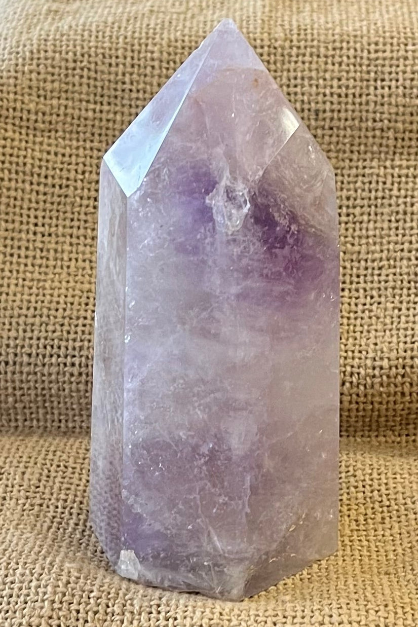 Purple amethyst stone from the back view. Inclusions are not visible from this angle, but some areas do have a deeper purple color.