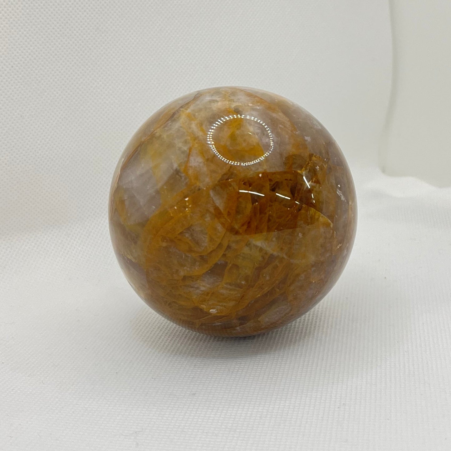 Clear crystal with light brown inclusions crystalized throughout