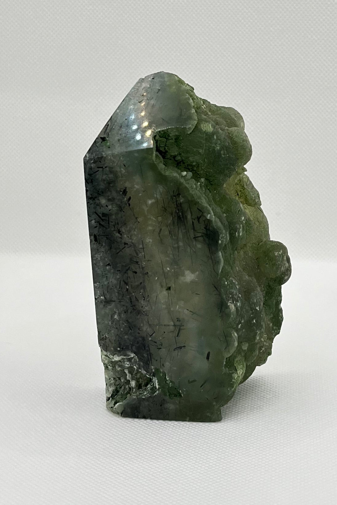 Green chunk of prehnite, with some sides polished and others raw