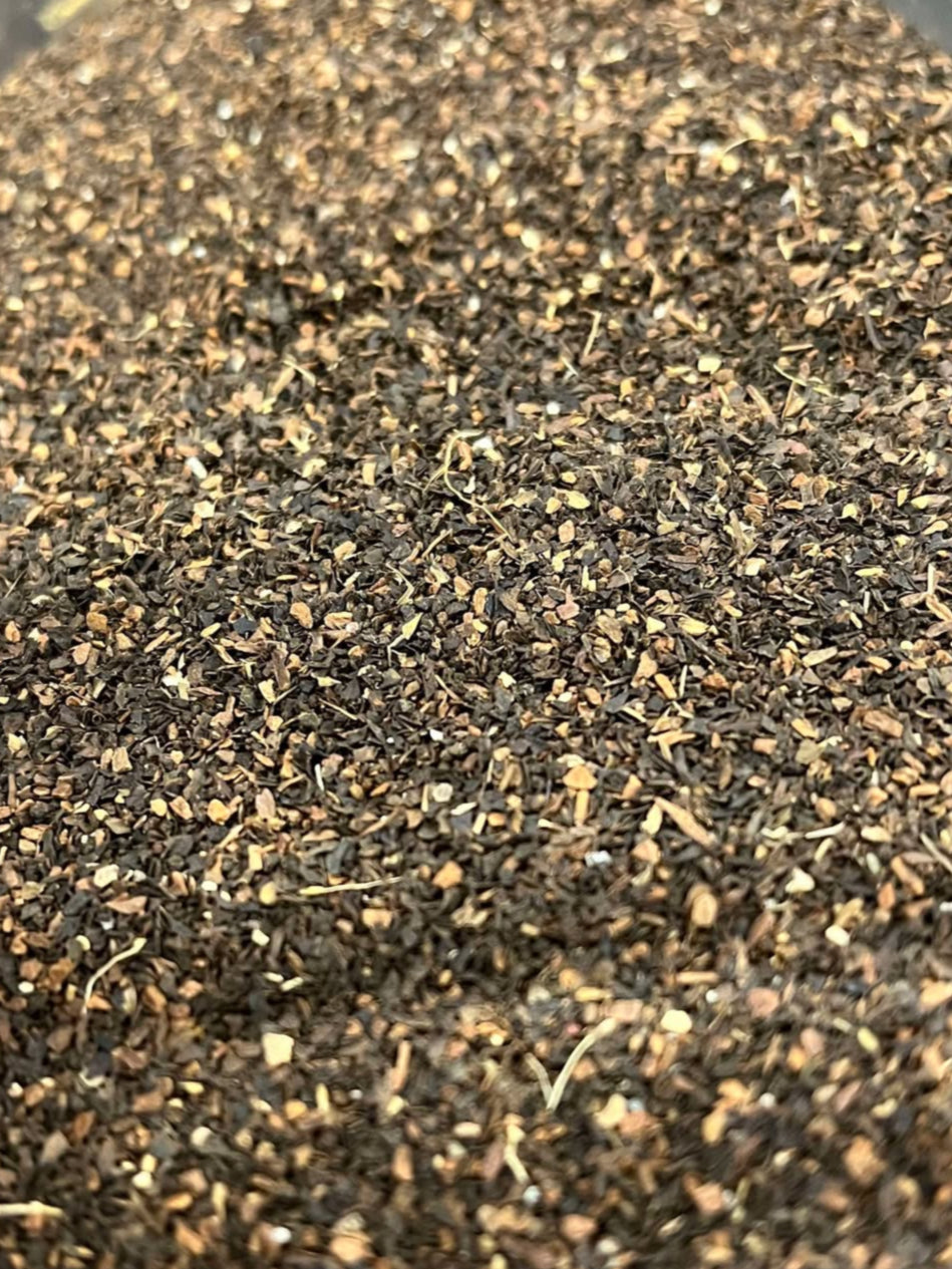 Brown and tan tea blend is finely ground and loose. 