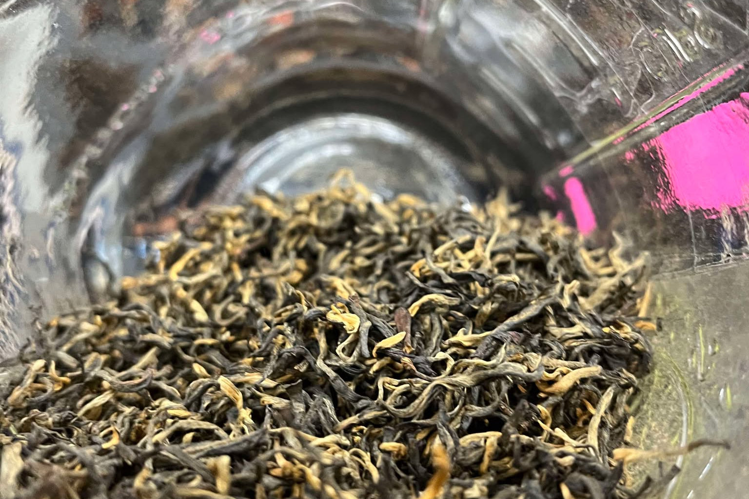 Brown and tan tea leaves in a clear jar. 