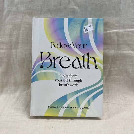 Book titled 'Follow Your Breath' on a light fabric background