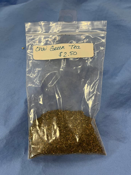 Finely ground brown leaves in a clear package labeled "Chai Green Tea, $2.50 per oz" 