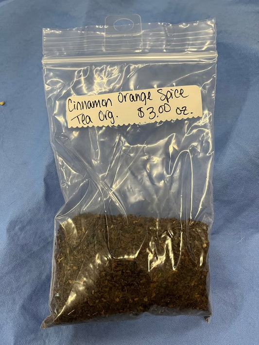 Coffee-colored leaves in plastic zip package, with label saying "Cinnamon Orange Spice Tea (Organic), $3 per oz." 