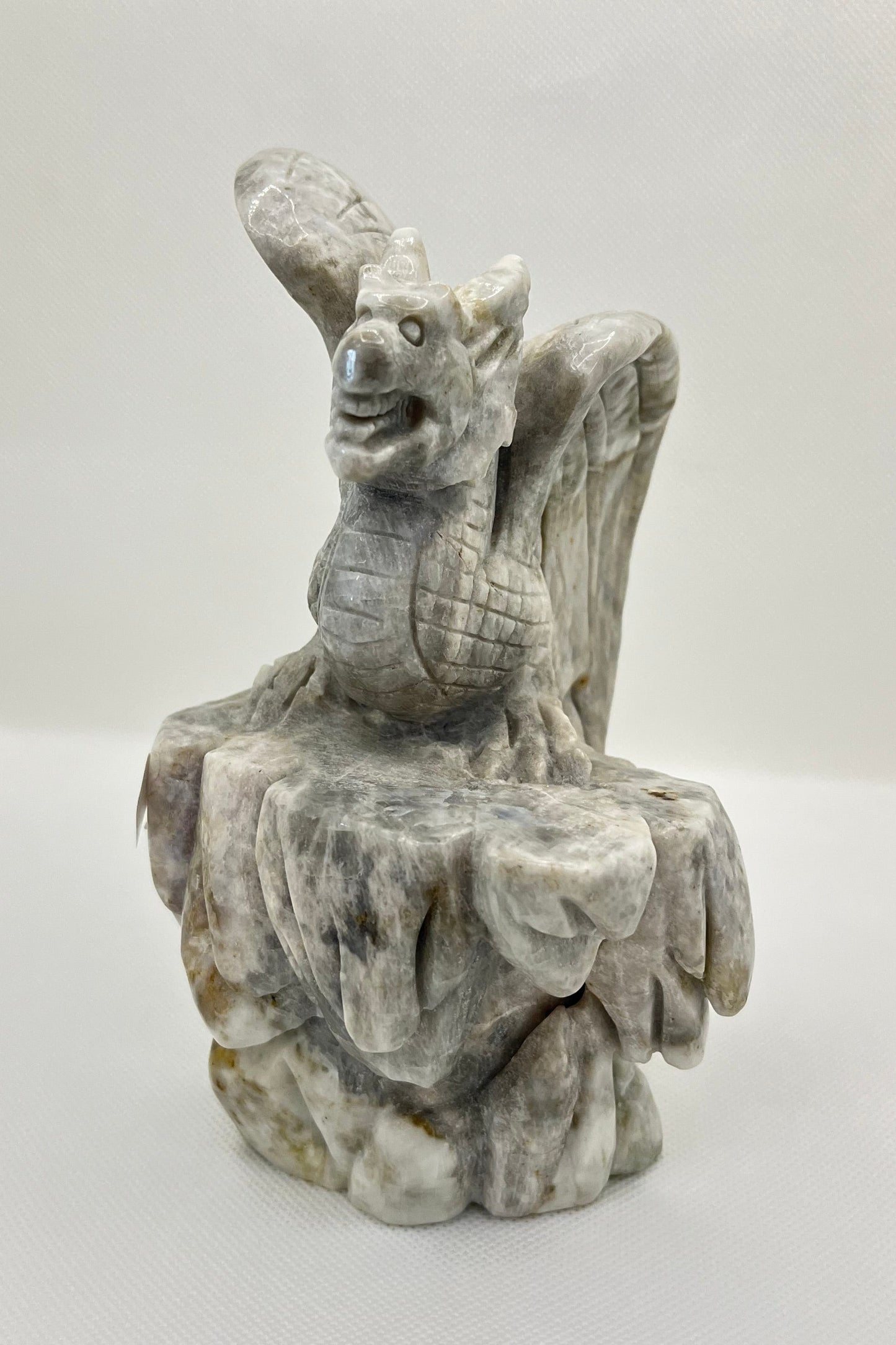 Stone gargoyle sculpture on a white background