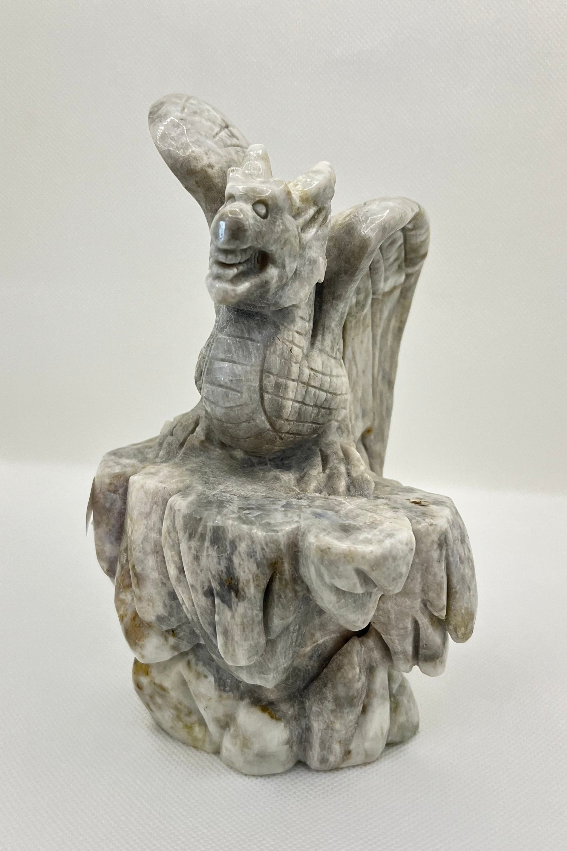 Stone gargoyle sculpture on a white background