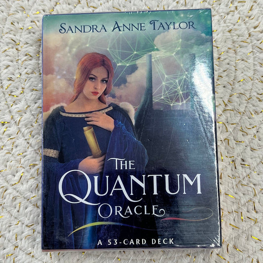 Packaging of 'The Quantum Oracle' card deck by Sandra Anne Taylor on a textured surface.