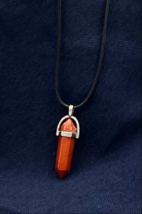 Double-pointed red jasper pendant held in place by metal finding
