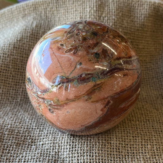 Brown and rust textured stone on a textured fabric background