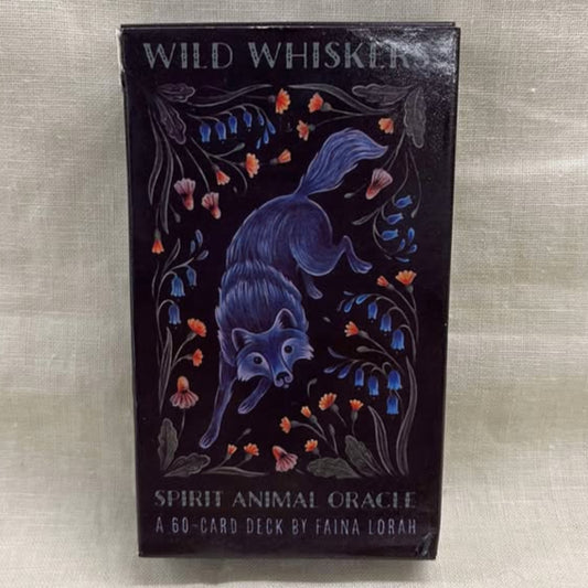 Ornate packaging of 'Wild Whiskers Spirit Animal Oracle' featuring a fox surrounded by flowers on a textured beige background