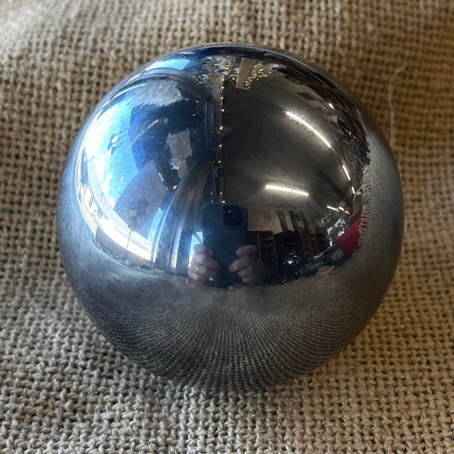 Metallic sphere on a textured fabric surface